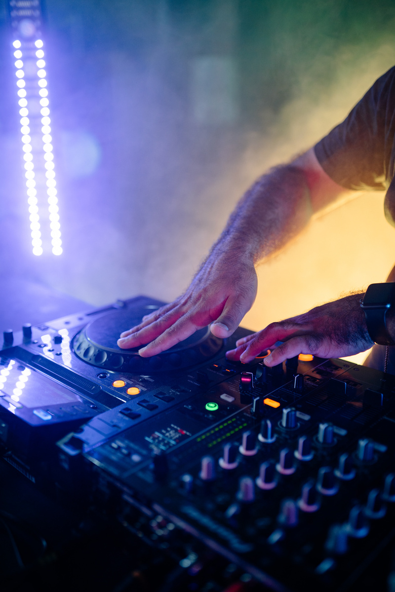 Person Playing Audio Mixer With Blue Light