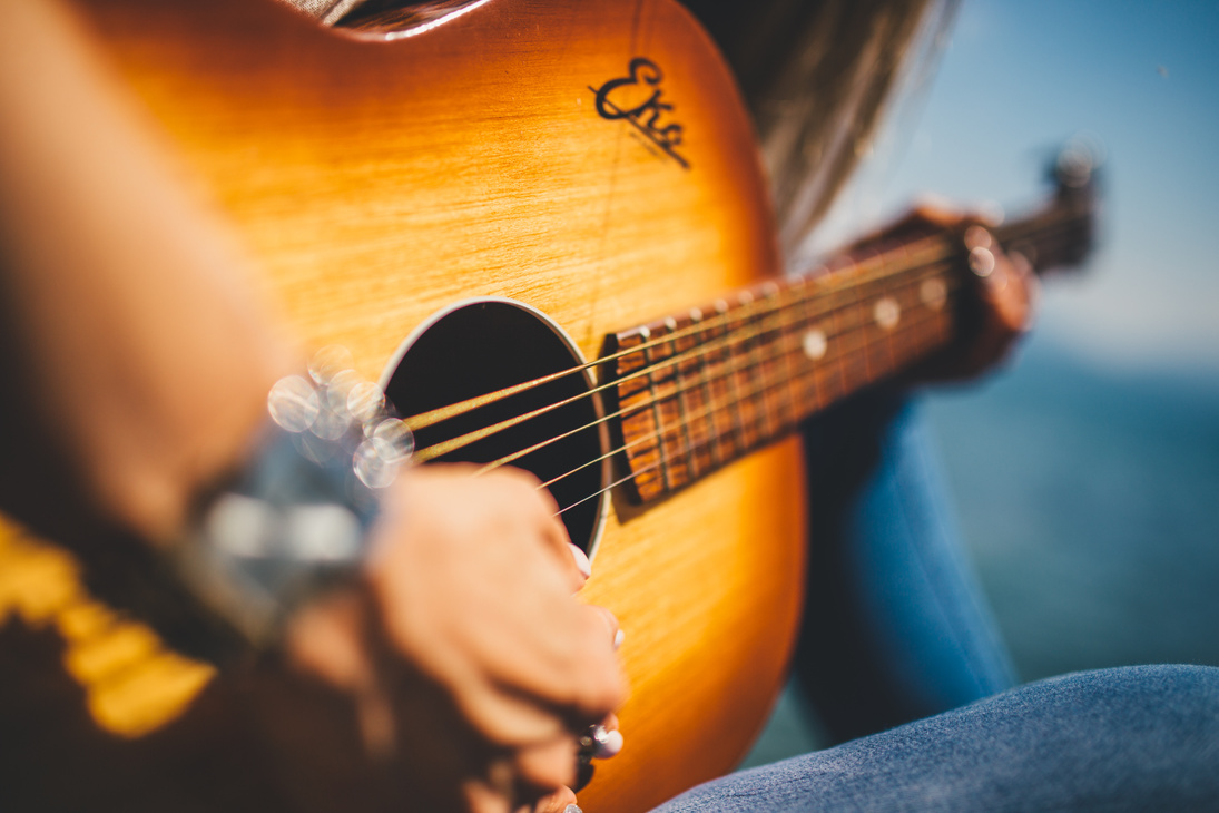 Person Play Guitar in Close-up Photo